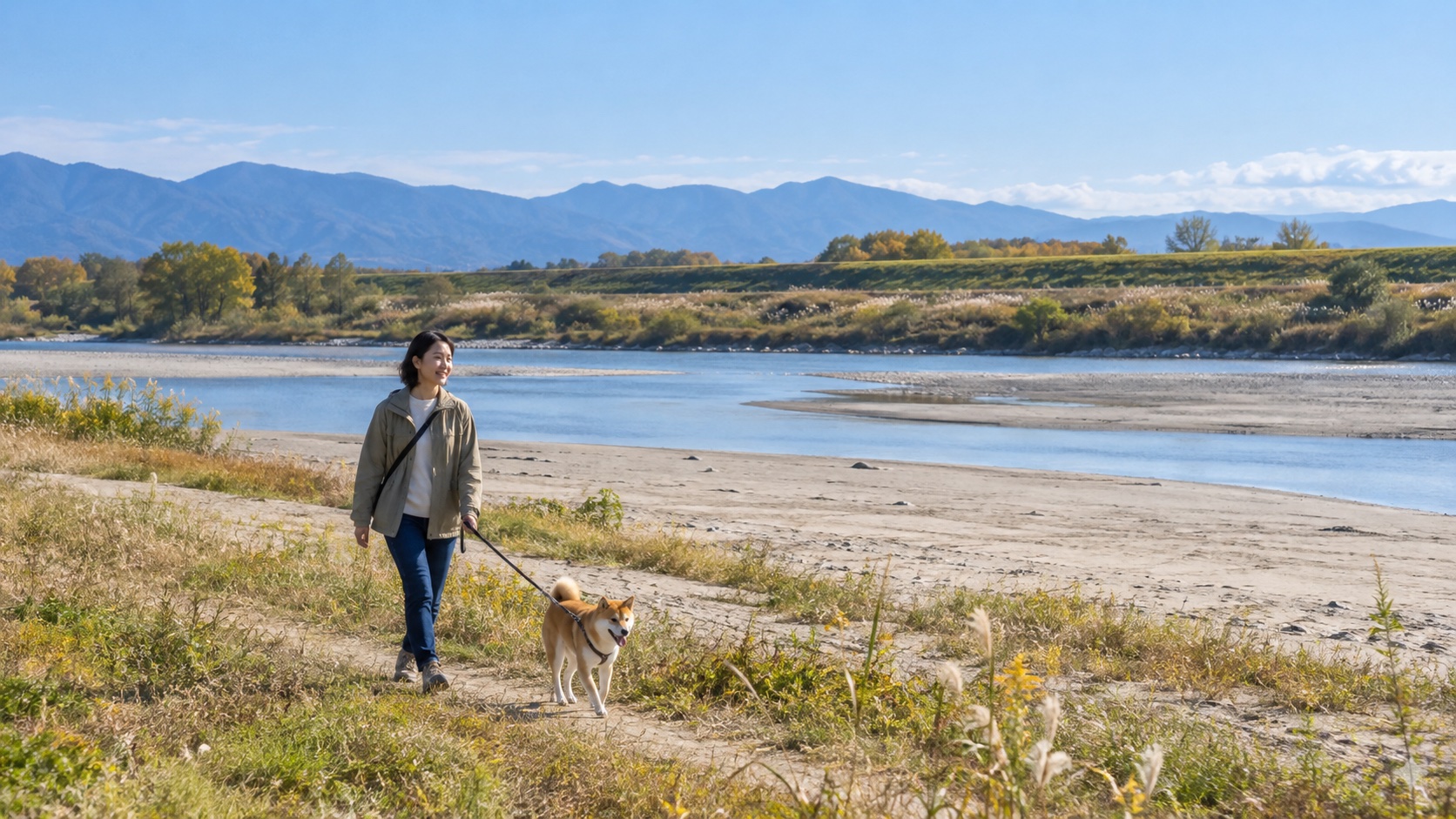 木曽川沿いの砂地と草地を短いリードで犬と歩く様子を表したテーマ画像